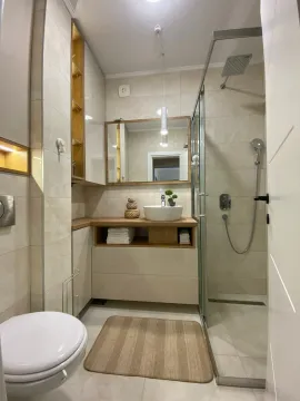 Modern bathroom with a walk-in shower, washbasin, and fitted cabinetry. - image 10