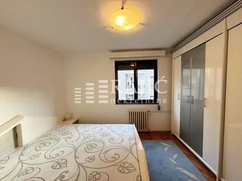 Bedroom with a double bed, large wardrobe, and window. - image 10