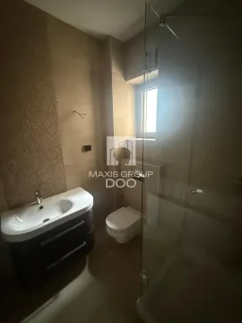 Clear bathroom with a vanity, toilet, and walk-in shower. - image 16