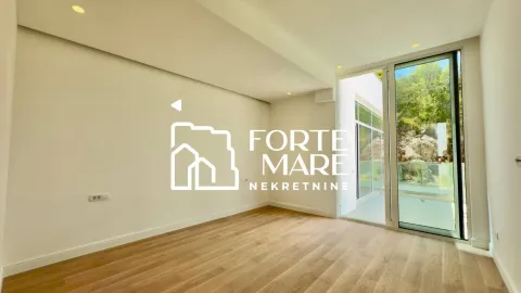 Empty room with wooden flooring and access to the terrace. - image 13