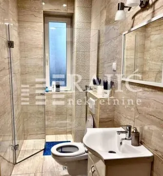 Modernly equipped bathroom with a walk-in shower. - image 5