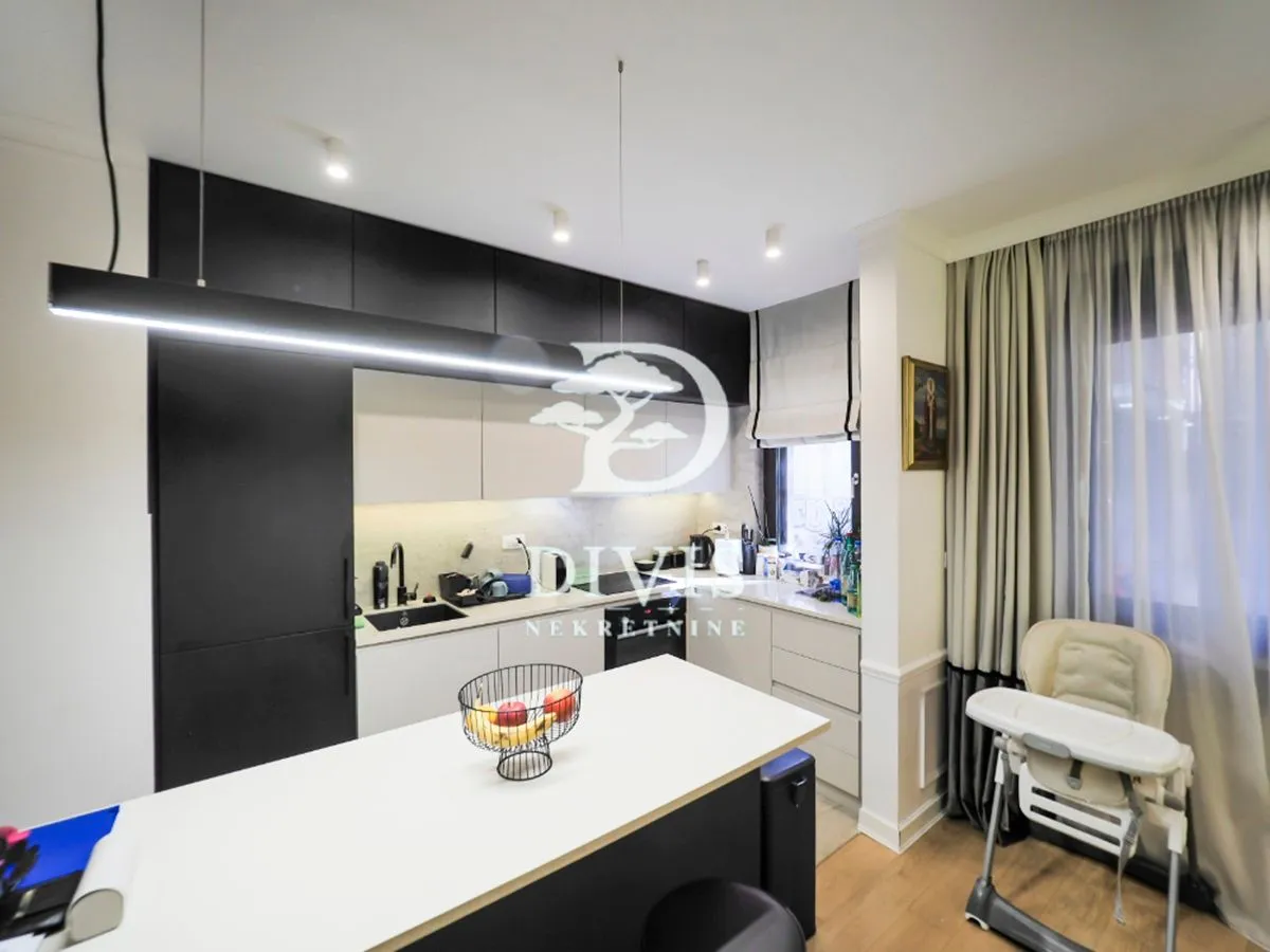 Modern kitchen with dark elements and an island.