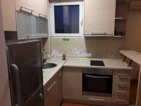 Smaller kitchen with built-in cabinetry and appliances. - image 5