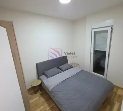 Smaller bedroom with a double bed and parquet flooring. - image 15