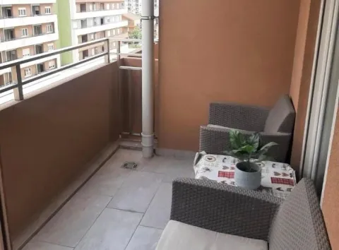 Furnished balcony with seating set and view of surrounding buildings. - image 10