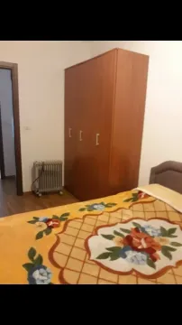 Bedroom with a wardrobe and a bed. - image 8