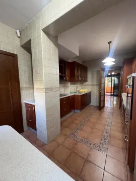 Kitchen with wooden cabinets and ceramic tiles. - image 19