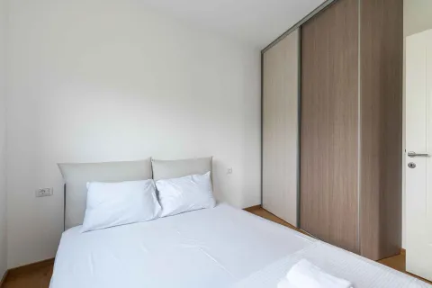 Bright bedroom with a double bed and a fitted wardrobe. - image 15