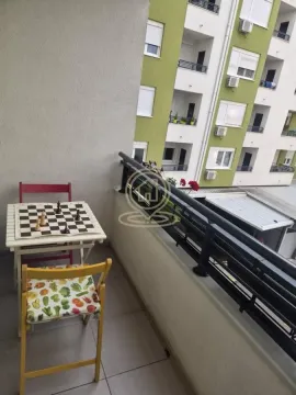 Small balcony with a chess table and a view of neighboring buildings. - image 18