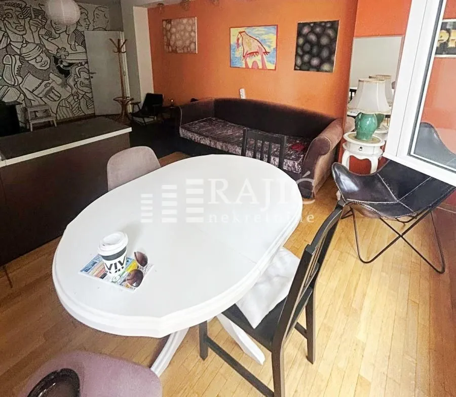 Living room with a dining table and sofa.
