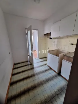 Small kitchen with white cabinets and ceramic wall tiles. - image 5