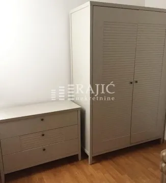 Bedroom with a large wardrobe and a dresser on parquet flooring. - image 10