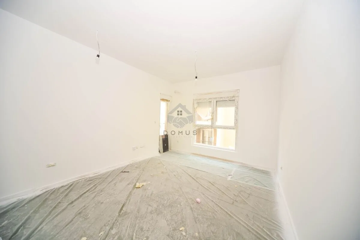 An empty room with white walls prepared for renovation.