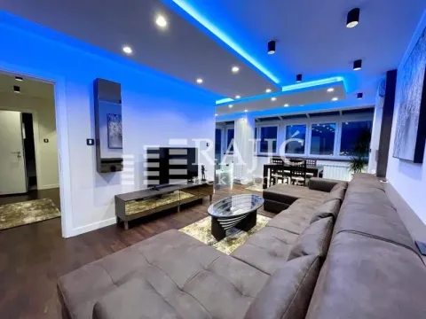 Living room with sofa, TV and modern lighting. - image 2
