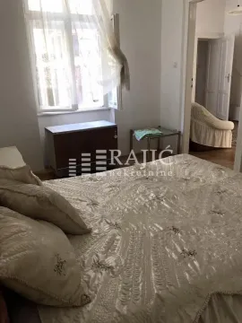 Furnished bedroom with a large double bed and a window. - image 7