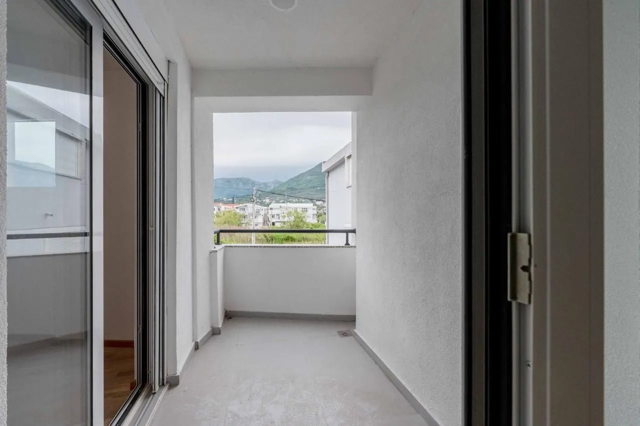 Empty covered balcony with mountain view.