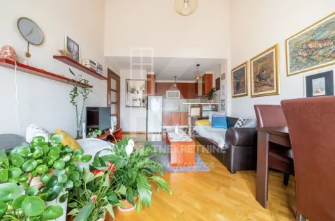 Living room with a sofa set and a view of the kitchen in the background. - image 2