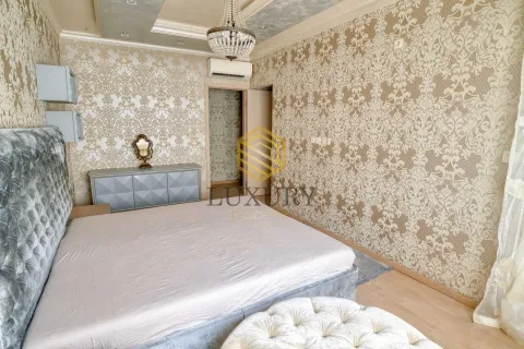 Bedroom with a double bed, patterned wallpaper, and a chandelier. - image 14