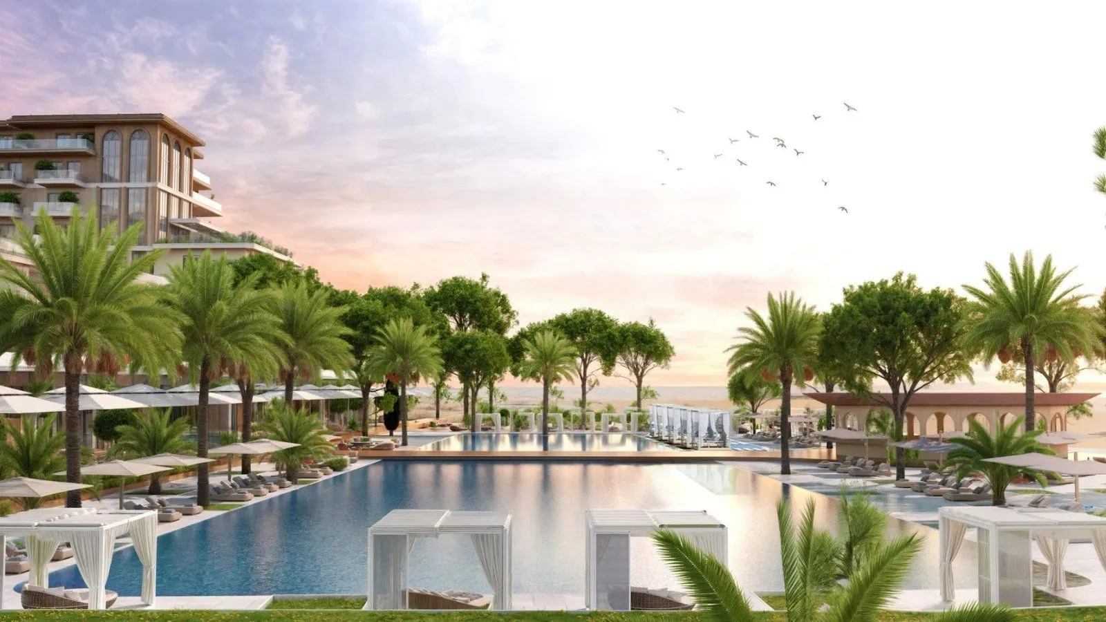 View of the outdoor swimming pool and part of the complex with palm trees.