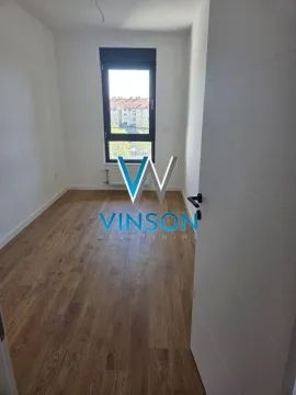 Empty room with wooden flooring and a window. - image 9