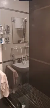Bathroom with a shower cabin, washbasin, and mirror. - image 7
