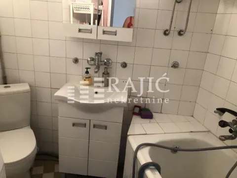 Smaller bathroom with a sink, toilet, and bathtub. - image 7