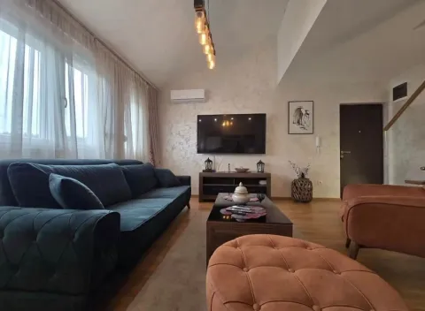 Spacious living room with a sofa set and a wall-mounted TV. - image 12