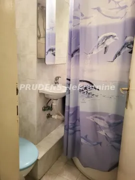 Smaller bathroom with a shower cabin, washbasin, and mirror. - image 16