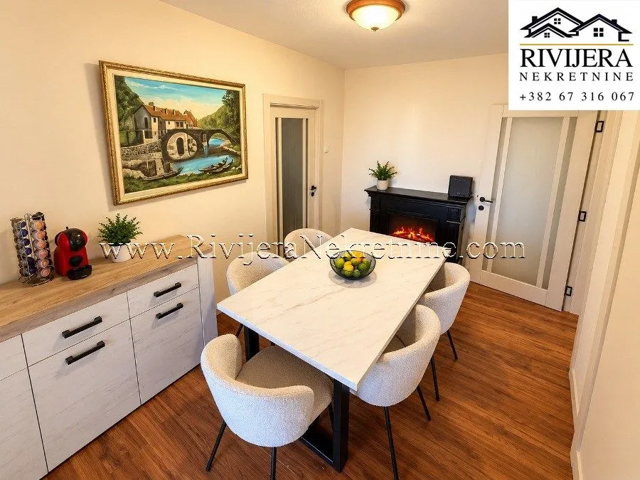 Dining room with a dining table, chairs, and a chest of drawers in the apartment.