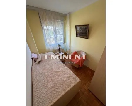 Smaller bedroom with a bed, an armchair, and a window. - image 10