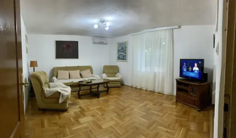 Living room with a seating set, television, and parquet flooring. - image 7