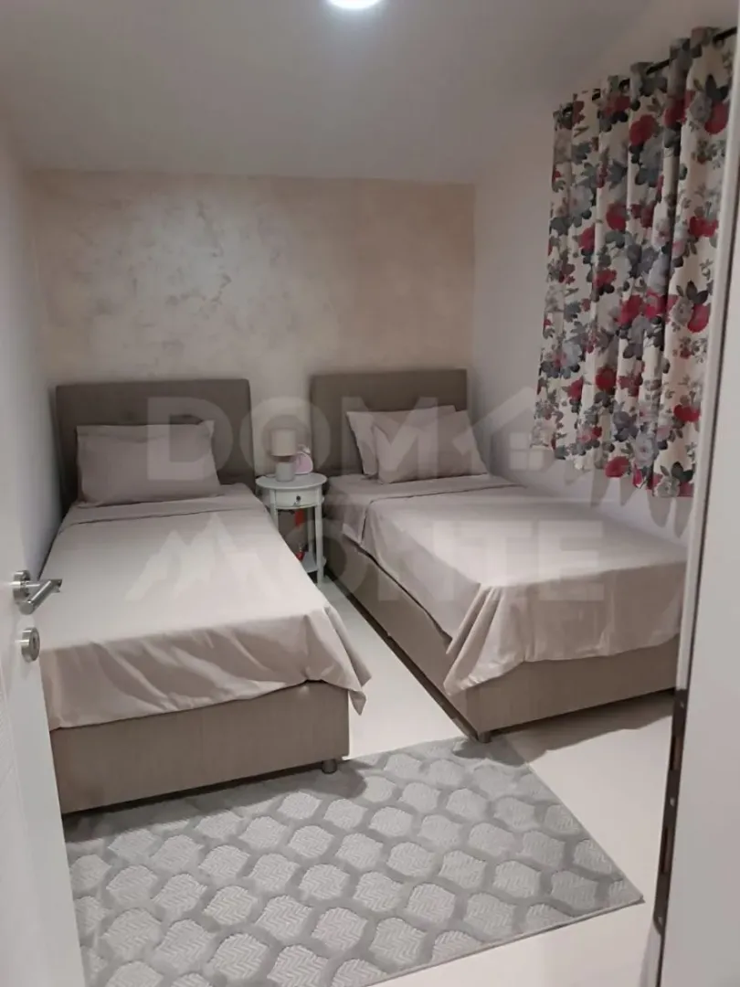 Bedroom with two single beds and a nightstand.