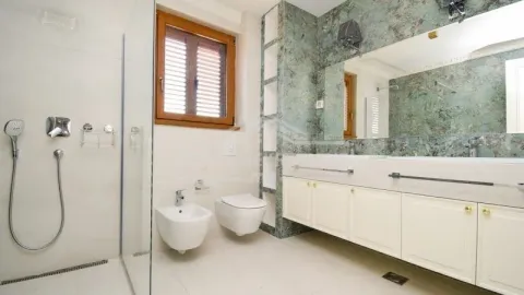 Svijetlo i prostrano kupatilo sa tuš kabinom, bideom i velikim ogledalom. - image 3