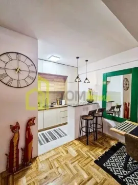 Modern kitchen with a bar counter and dining area. - image 5