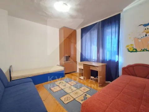 Children's bedroom with two beds, a desk, and a wardrobe. - image 5
