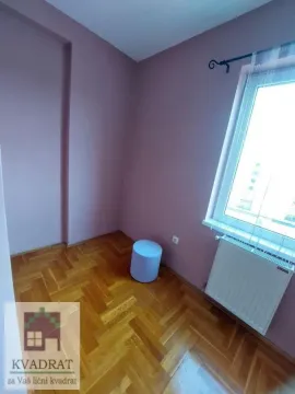 Empty room with pink walls, wooden parquet flooring, and a window. - image 18