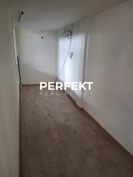 Empty room with laminate flooring and white walls. - image 2