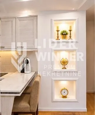 Small kitchen with a breakfast bar and decorative recessed wall niches.
