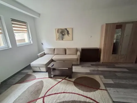 Living room with a sectional sofa, coffee table, wardrobe, and windows. - image 16