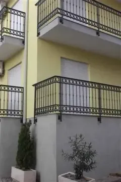 View of the exterior of the building with balconies and decorative railings. - image 10