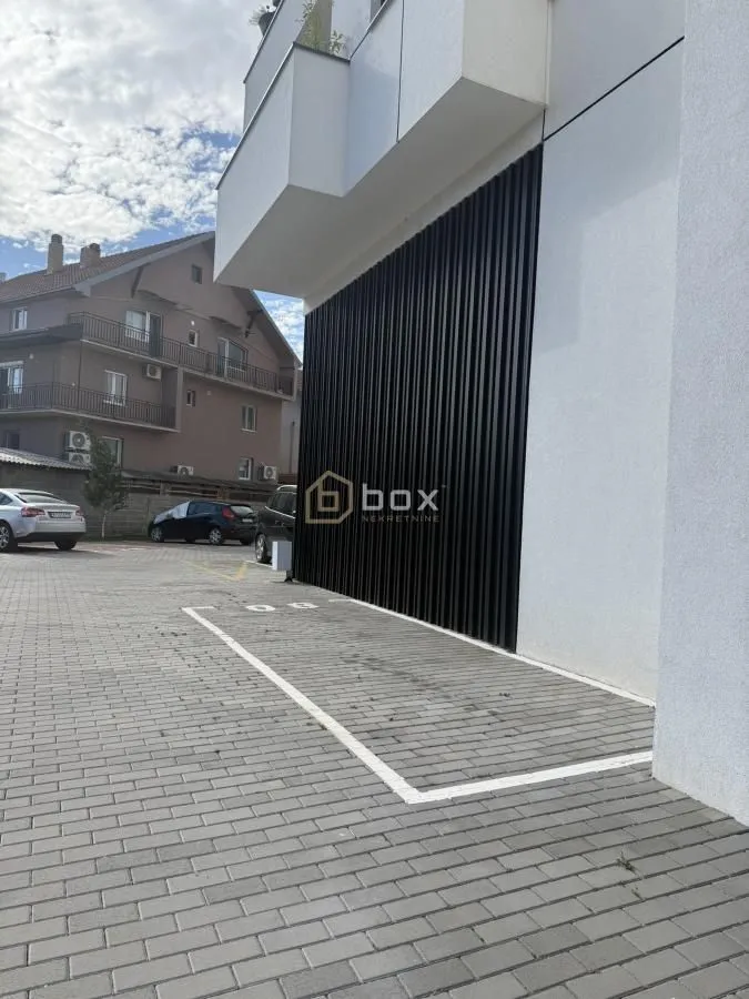 View of the exterior of the building with a designated parking space.