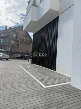View of the exterior of the building with a designated parking space. - image 5