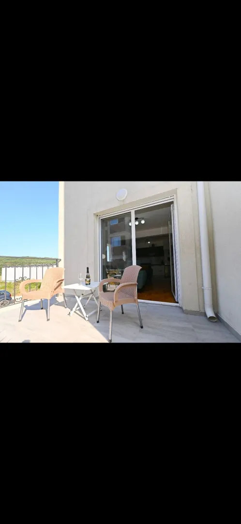 Balcony with seating furniture and a view.