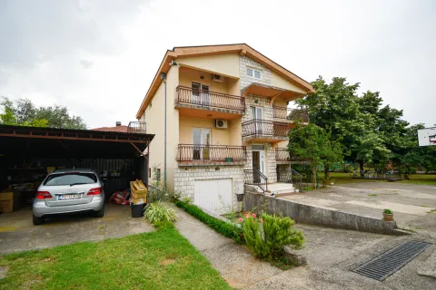 View of the exterior of the house with a garage and yard. - image 6