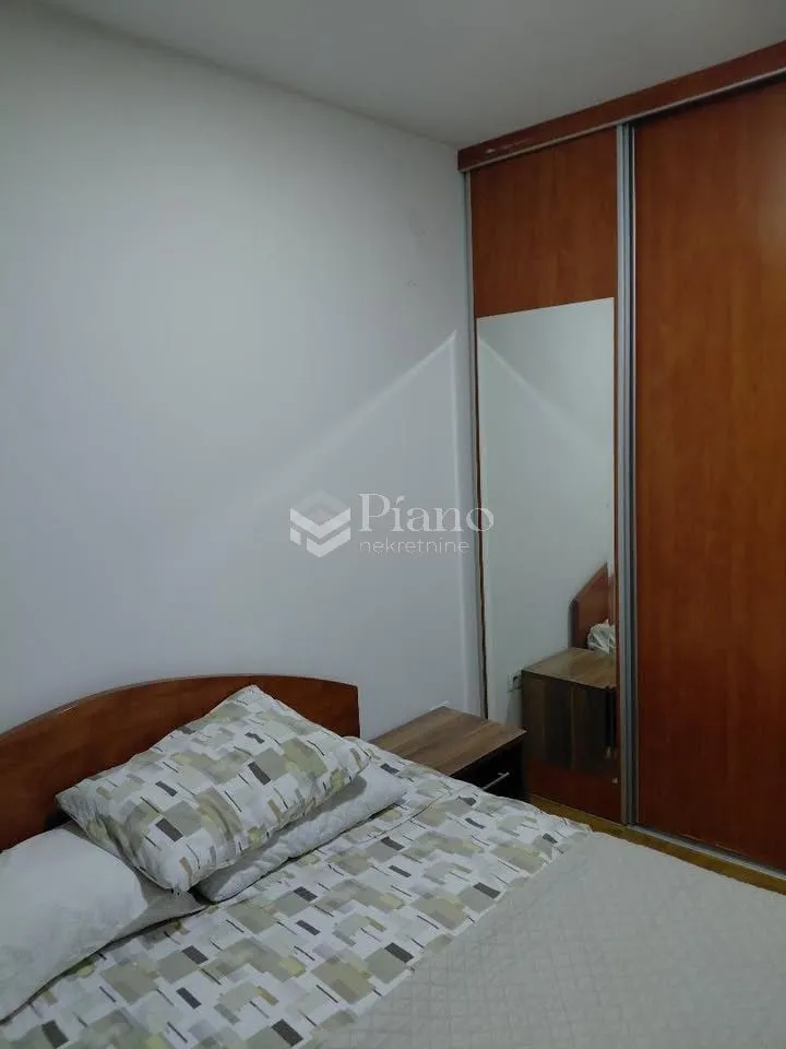 Bedroom with a double bed and a fitted wardrobe with a mirror.