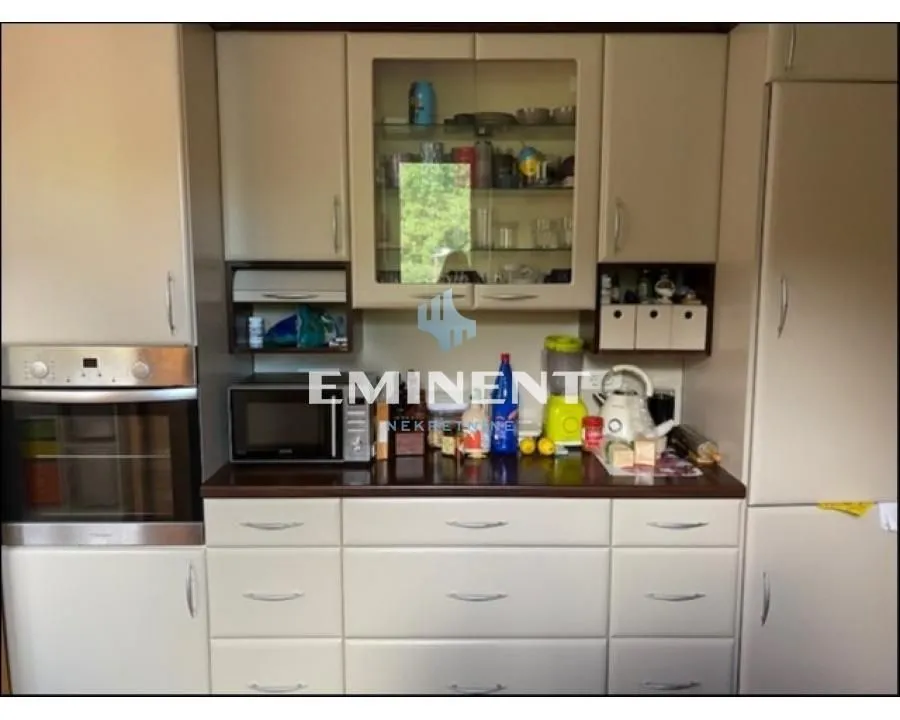 Kitchen with cabinetry and built-in oven.