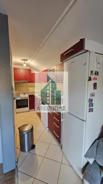 Small kitchen with wood-toned cabinets and white goods. - image 4