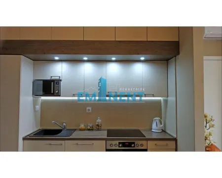 A view of a modern equipped kitchen with built-in elements and lighting. - image 6