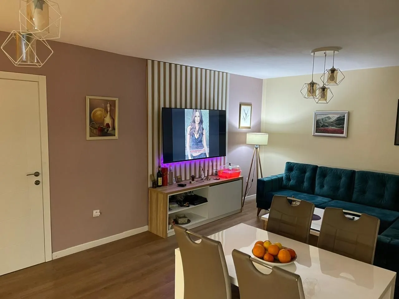 Bright living room featuring a dining table and a green sofa.