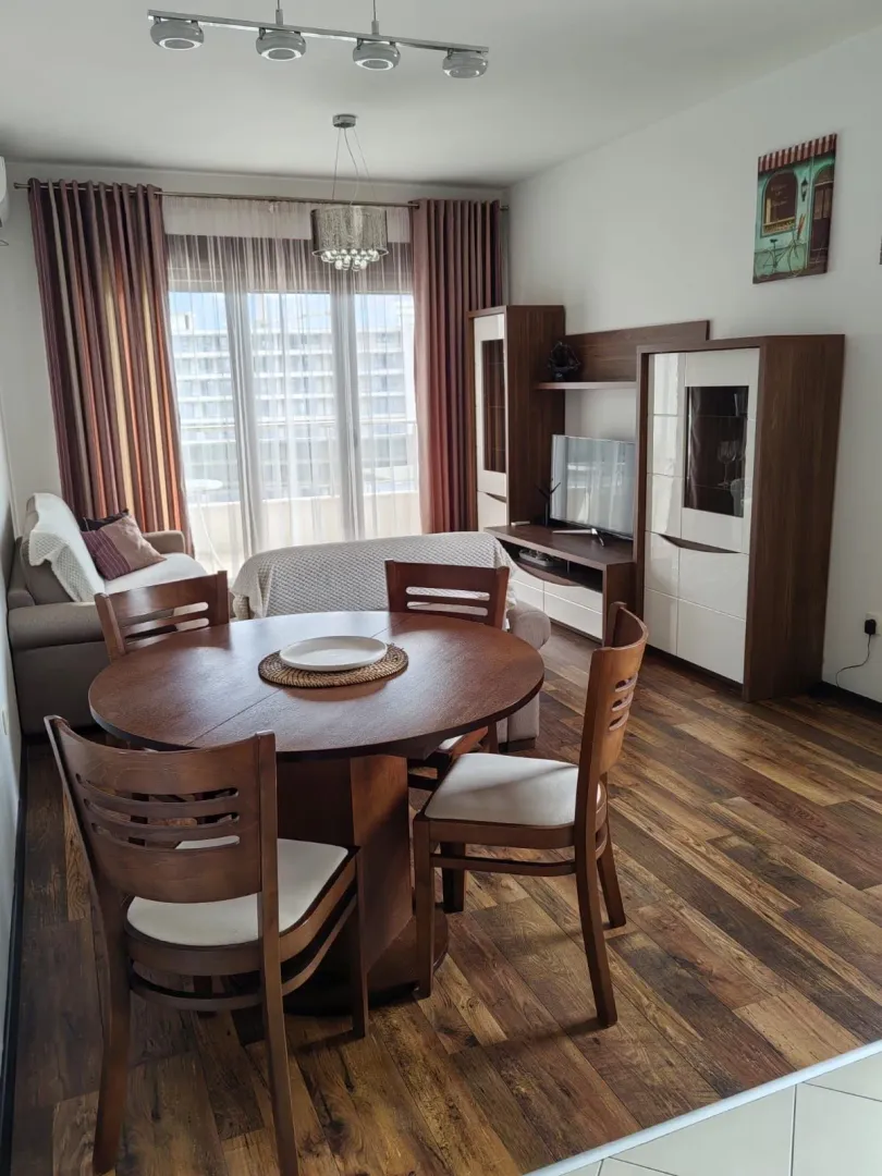 Living room with a dining table and wooden furniture.